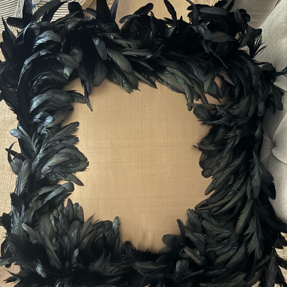 Austin Horn Gold Silk Accent Pillow with black iridescent feathers.